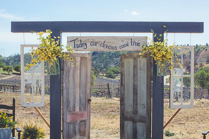 rustic wedding ceremony with doors and today our lives become one sign | Ceremony Backdrops Doors | photo: Lindsey Gomes