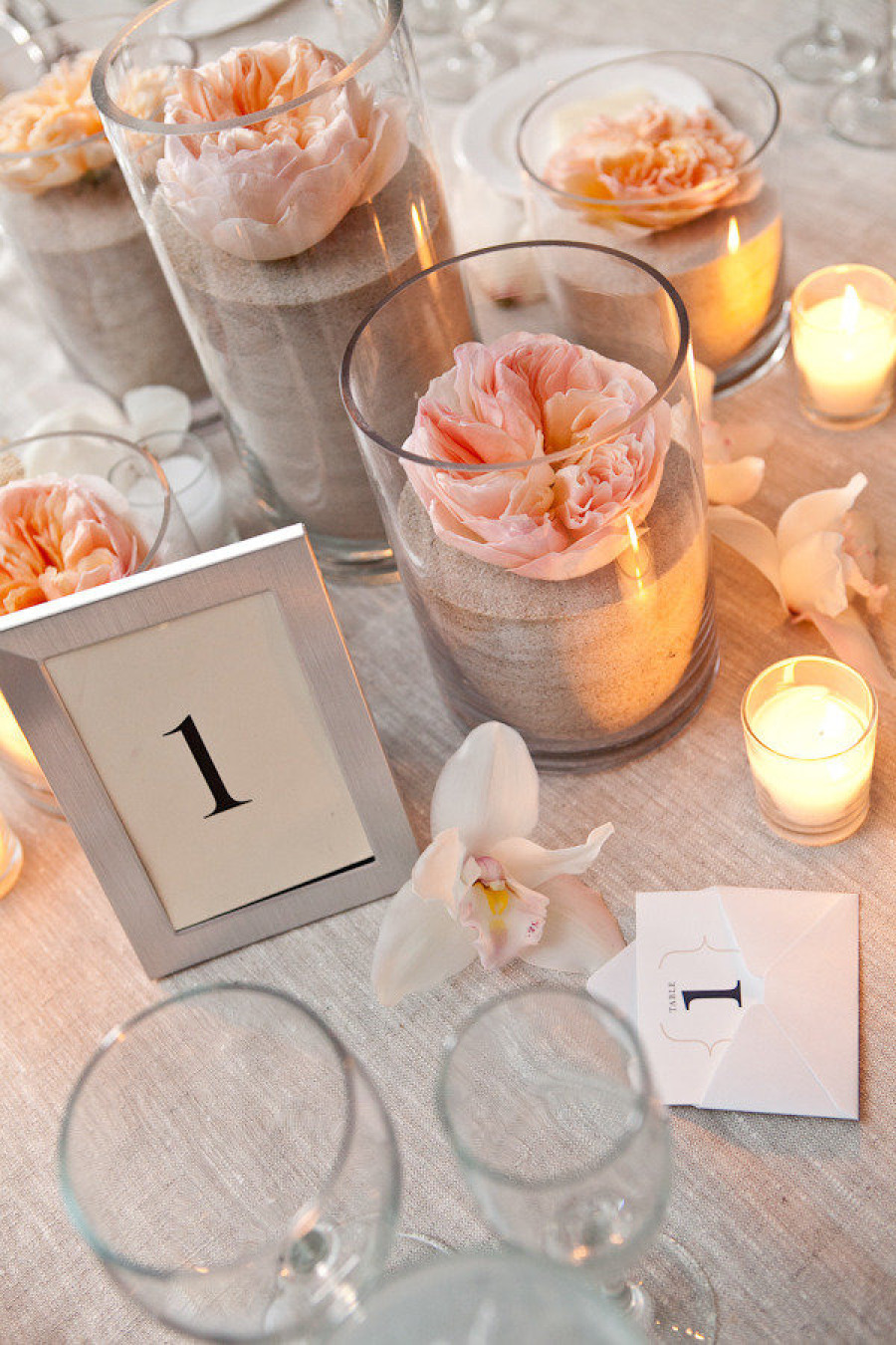 sand in votive candle holders | photo: tory williams | via decorate for beach wedding ideas from emmalinebride.com