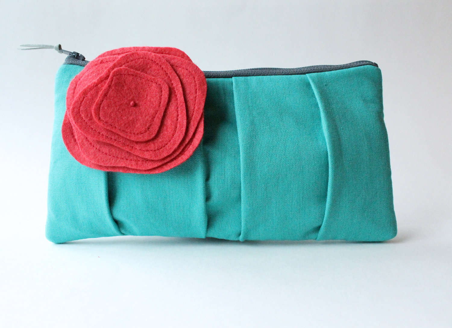 teal clutch purse with coral brooch pin flower | 7 Spring Wedding Clutches Your Girls Will Love via emmalinebride.com