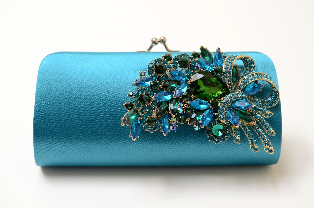 teal clutch with peacock brooch