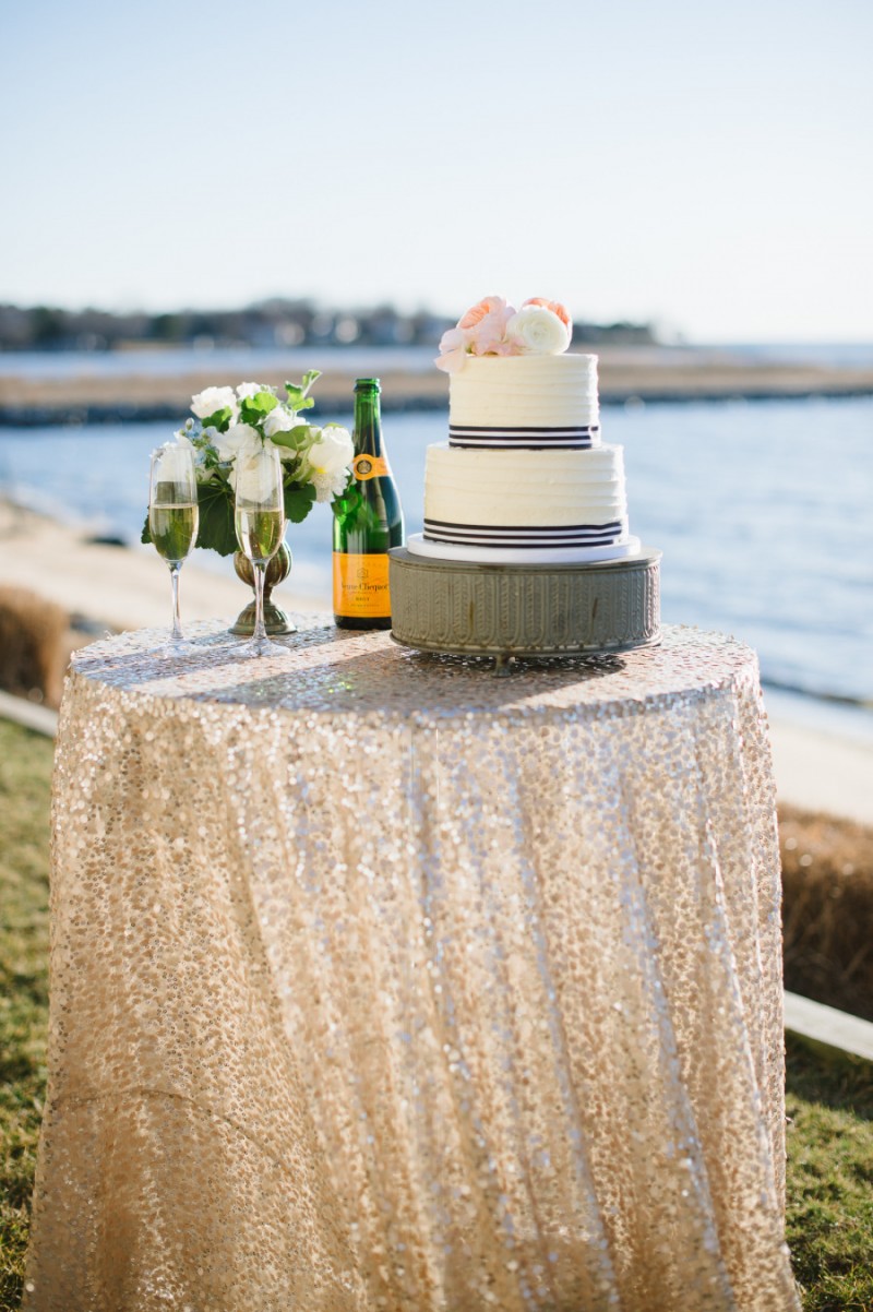 wedding cake with navy blue and white striped ribbon, photo: natalie franke | via https://emmalinebride.com/decor/navy-and-white-wedding-ideas/ | from 21 Navy and White Wedding Ideas