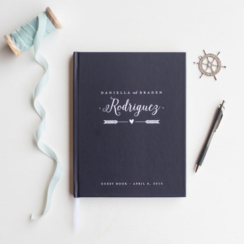 wedding guest book with arrow and personalized name in navy by starboard press