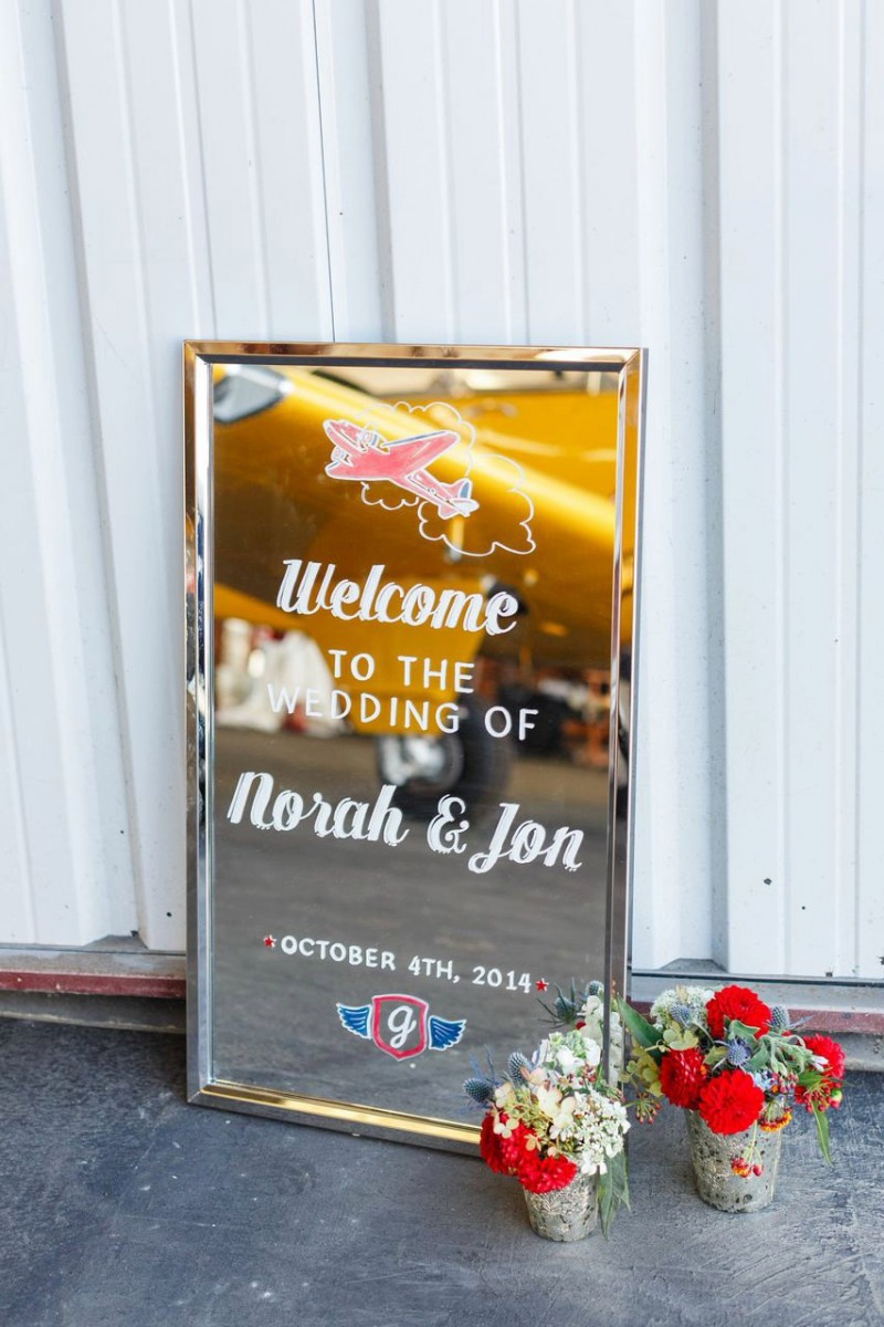 This welcome sign features the couple's travel theme | https://emmalinebride.com/decor/wedding-mirror-signs/
