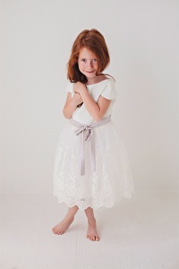 white lace flower girl dress with light purple bow sash
